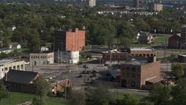 5.7K aerial stock footage abandoned buildings by a street intersection in Detroit, Michigan Aerial Stock Footage | DX0002_195_037