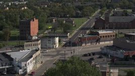 5.7K aerial stock footage orbit a street intersection with abandoned buildings and shops in Detroit, Michigan Aerial Stock Footage | DX0002_195_039