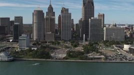 5.7K aerial stock footage of circling tall skyscrapers behind Hart Plaza, Downtown Detroit, Michigan Aerial Stock Footage | DX0002_196_013