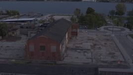 5.7K aerial stock footage orbit an abandoned Northern Cranes factory building at sunset, Detroit, Michigan Aerial Stock Footage | DX0002_197_013