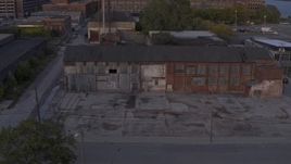 5.7K aerial stock footage of circling an abandoned Northern Cranes factory building at sunset, Detroit, Michigan Aerial Stock Footage | DX0002_197_014