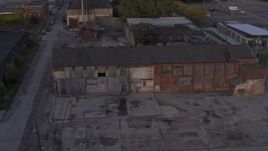 5.7K aerial stock footage descend by abandoned factory building at sunset, Detroit, Michigan Aerial Stock Footage | DX0002_197_016
