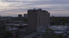 5.7K aerial stock footage of slowly orbiting an apartment building at sunset, Detroit, Michigan Aerial Stock Footage | DX0002_197_018