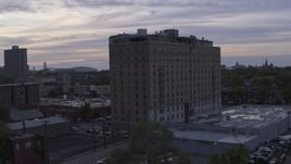 5.7K aerial stock footage of an orbit around an apartment building at sunset, Detroit, Michigan Aerial Stock Footage | DX0002_197_019