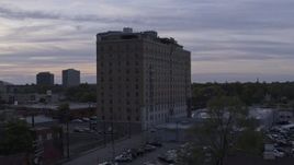 5.7K aerial stock footage of descending by an apartment building at sunset, Detroit, Michigan Aerial Stock Footage | DX0002_197_021