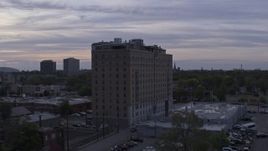 5.7K aerial stock footage of ascending by an apartment building at sunset, Detroit, Michigan Aerial Stock Footage | DX0002_197_022