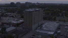 5.7K aerial stock footage of flying away from an apartment building at sunset, Detroit, Michigan Aerial Stock Footage | DX0002_197_023