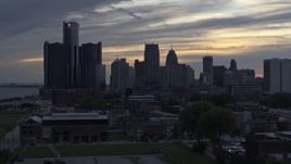 5.7K aerial stock footage focus on GM Renaissance Center and the city's skyline at sunset during ascent, Downtown Detroit, Michigan Aerial Stock Footage | DX0002_197_031