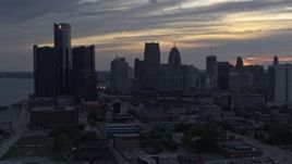 5.7K aerial stock footage reverse view of GM Renaissance Center and the city's skyline at sunset, Downtown Detroit, Michigan Aerial Stock Footage | DX0002_197_032