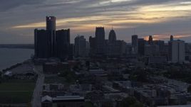 5.7K aerial stock footage of passing by GM Renaissance Center and the city's skyline at sunset, Downtown Detroit, Michigan Aerial Stock Footage | DX0002_197_033