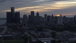 5.7K aerial stock footage ascend away from GM Renaissance Center and the skyline at sunset, Downtown Detroit, Michigan Aerial Stock Footage | DX0002_197_038