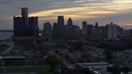 5.7K aerial stock footage of descending past the city's tall skyscrapers at sunset, Downtown Detroit, Michigan Aerial Stock Footage | DX0002_197_047