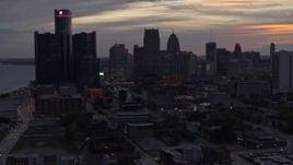5.7K aerial stock footage of slowly flying away from the city's towering skyscrapers at sunset, Downtown Detroit, Michigan Aerial Stock Footage | DX0002_198_004