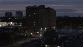 5.7K aerial stock footage descend and circle an apartment building at twilight, Detroit, Michigan Aerial Stock Footage | DX0002_198_024