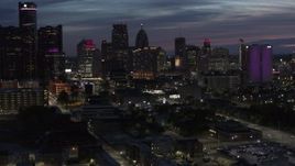 5.7K aerial stock footage of flying by and away from the city's skyline at twilight in Downtown Detroit, Michigan Aerial Stock Footage | DX0002_198_026
