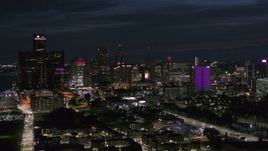 5.7K aerial stock footage of passing by the brightly lit city skyline at night, Downtown Detroit, Michigan Aerial Stock Footage | DX0002_198_034