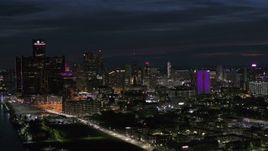 5.7K aerial stock footage flyby the brightly lit city skyline at night, Downtown Detroit, Michigan Aerial Stock Footage | DX0002_198_035