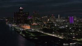 5.7K aerial stock footage of the brightly lit skyscrapers in the city skyline at night, Downtown Detroit, Michigan Aerial Stock Footage | DX0002_198_037