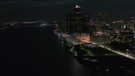 5.7K aerial stock footage of orbiting GM Renaissance Center seen from river at night, Downtown Detroit, Michigan Aerial Stock Footage | DX0002_198_043