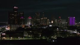 5.7K aerial stock footage ascend and approach the skyline at night, Downtown Detroit, Michigan Aerial Stock Footage | DX0002_198_049