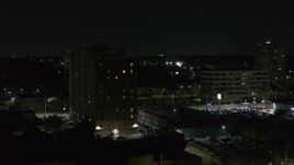 5.7K aerial stock footage descend and orbit an apartment building at night, Detroit, Michigan Aerial Stock Footage | DX0002_198_057