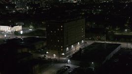 5.7K aerial stock footage focus on an apartment building while ascending at night, Detroit, Michigan Aerial Stock Footage | DX0002_198_061