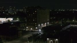 5.7K aerial stock footage descend while focused on Pasadena Apartments at nighttime, Detroit, Michigan Aerial Stock Footage | DX0002_198_062