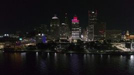 5.7K aerial stock footage stationary view of Hart Plaza and towering skyscrapers at night, Downtown Detroit, Michigan Aerial Stock Footage | DX0002_199_012