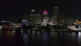 5.7K aerial stock footage focus on Hart Plaza and towering skyscrapers at night while descending by river, Downtown Detroit, Michigan Aerial Stock Footage | DX0002_199_013