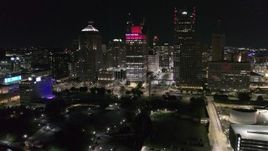 5.7K aerial stock footage a reverse view of Hart Plaza and towering skyscrapers at night, Downtown Detroit, Michigan Aerial Stock Footage | DX0002_199_016