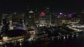 5.7K aerial stock footage slowly orbit Hart Plaza and skyscrapers at night, seen from the river, Downtown Detroit, Michigan Aerial Stock Footage | DX0002_199_019