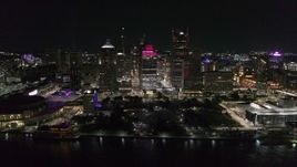 5.7K aerial stock footage of circling Hart Plaza and skyscrapers at night, seen from the river, Downtown Detroit, Michigan Aerial Stock Footage | DX0002_199_020