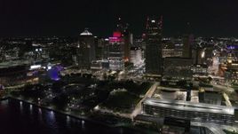 5.7K aerial stock footage of orbiting Hart Plaza by tall skyscrapers at night, seen from the river, Downtown Detroit, Michigan Aerial Stock Footage | DX0002_199_021