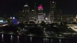 5.7K aerial stock footage orbit Hart Plaza, focus on tall skyscrapers at night, Downtown Detroit, Michigan Aerial Stock Footage | DX0002_199_023