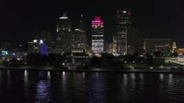 5.7K aerial stock footage descend by riverfront Hart Plaza, focus on tall skyscrapers at night, Downtown Detroit, Michigan Aerial Stock Footage | DX0002_199_025