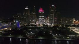 5.7K aerial stock footage ascend by riverfront Hart Plaza, focus on tall skyscrapers at night, Downtown Detroit, Michigan Aerial Stock Footage | DX0002_199_026