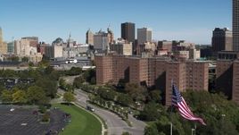 5.7K aerial stock footage descend by apartment buildings with view of skyline, Downtown Buffalo, New York Aerial Stock Footage | DX0002_200_006