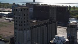 5.7K aerial stock footage circling a large grain elevator in Buffalo, New York Aerial Stock Footage | DX0002_201_023