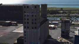 5.7K aerial stock footage of circling around a large grain elevator in Buffalo, New York Aerial Stock Footage | DX0002_201_024