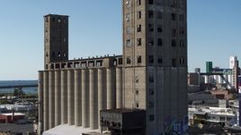 5.7K aerial stock footage of descending beside a large grain elevator in Buffalo, New York Aerial Stock Footage | DX0002_201_026