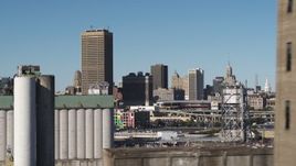 5.7K aerial stock footage pass grain elevators for view of the city's skyline and baseball stadium, Downtown Buffalo, New York Aerial Stock Footage | DX0002_201_034