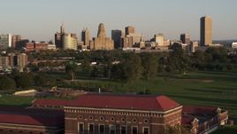 5.7K aerial stock footage ascend over water filtration plant to approach city hall and skyline at sunset, Downtown Buffalo, New York Aerial Stock Footage | DX0002_203_037