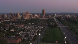 5.7K aerial stock footage wide view of Seneca One Tower and the city's skyline seen from neighborhood at twilight, Downtown Buffalo, New York Aerial Stock Footage | DX0002_204_033