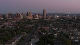 5.7K aerial stock footage wide view of Seneca One Tower and the city's skyline seen from homes at twilight, Downtown Buffalo, New York Aerial Stock Footage | DX0002_204_034