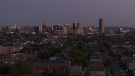 5.7K aerial stock footage of the skyline seen while descending near apartments at twilight, Downtown Buffalo, New York Aerial Stock Footage | DX0002_204_039