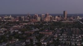 5.7K aerial stock footage of flying by the skyline seen from apartments and homes at twilight, Downtown Buffalo, New York Aerial Stock Footage | DX0002_204_041