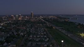 5.7K aerial stock footage of skyscraper seen from I-190 and neighborhoods at twilight, Downtown Buffalo, New York Aerial Stock Footage | DX0002_204_046