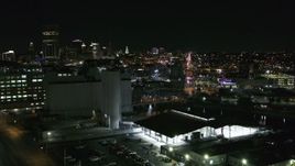 5.7K aerial stock footage of flying by grain elevators with a view of the skyline at night, Downtown Buffalo, New York Aerial Stock Footage | DX0002_205_007