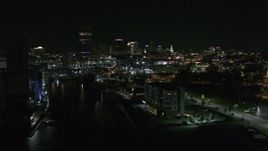 5.7K aerial stock footage of following Buffalo River toward the skyline at night, Downtown Buffalo, New York Aerial Stock Footage | DX0002_205_009