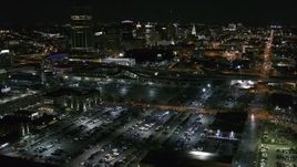 5.7K aerial stock footage of flying away from parking lots and skyline at night, Downtown Buffalo, New York Aerial Stock Footage | DX0002_205_011